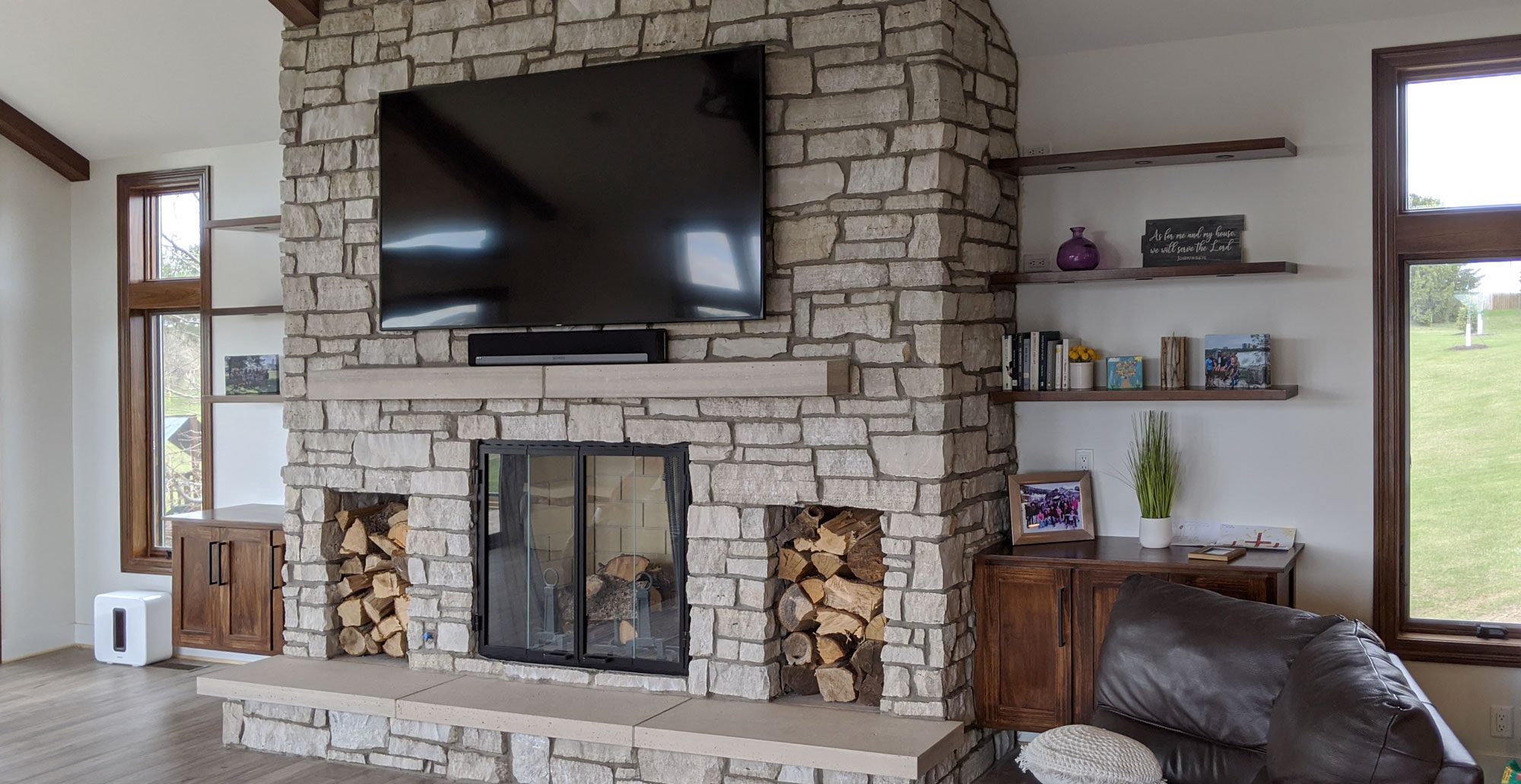 Living Room With Stone Fireplace And Tv