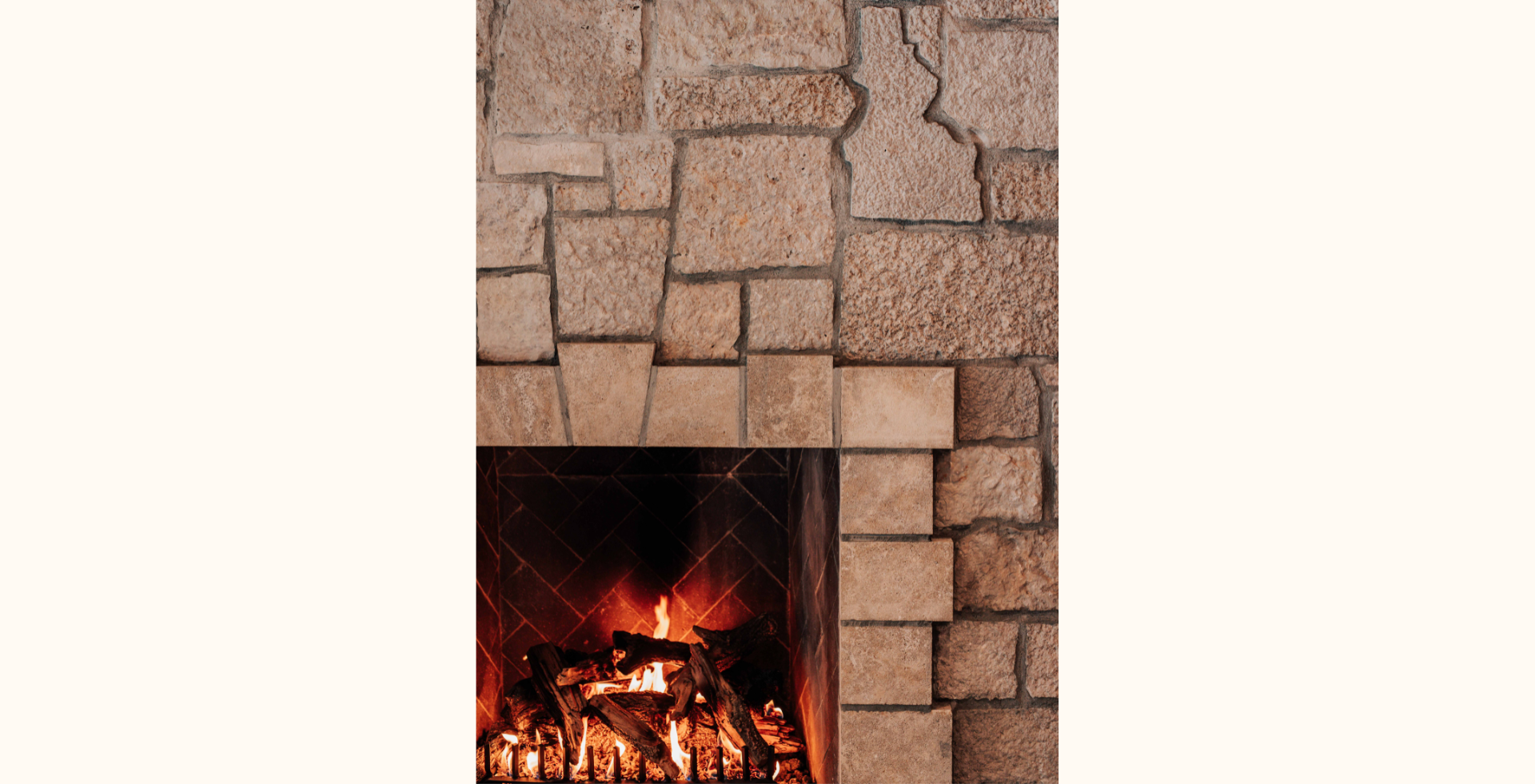 A fireplace crafted with Buechel Stone continues the charming Old-World stylings.